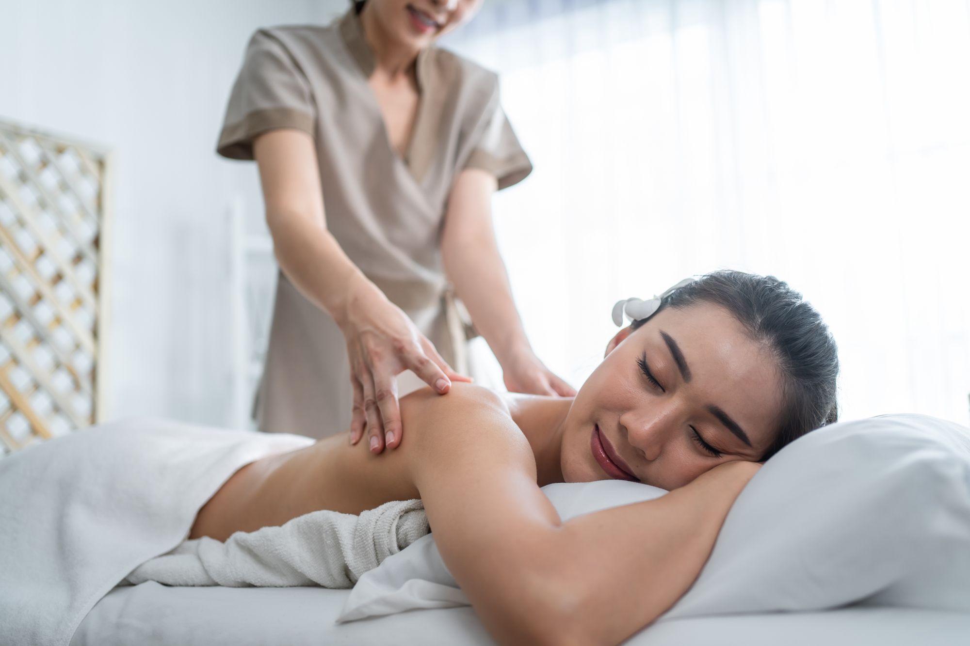 Massage therapist rubbing the client's back